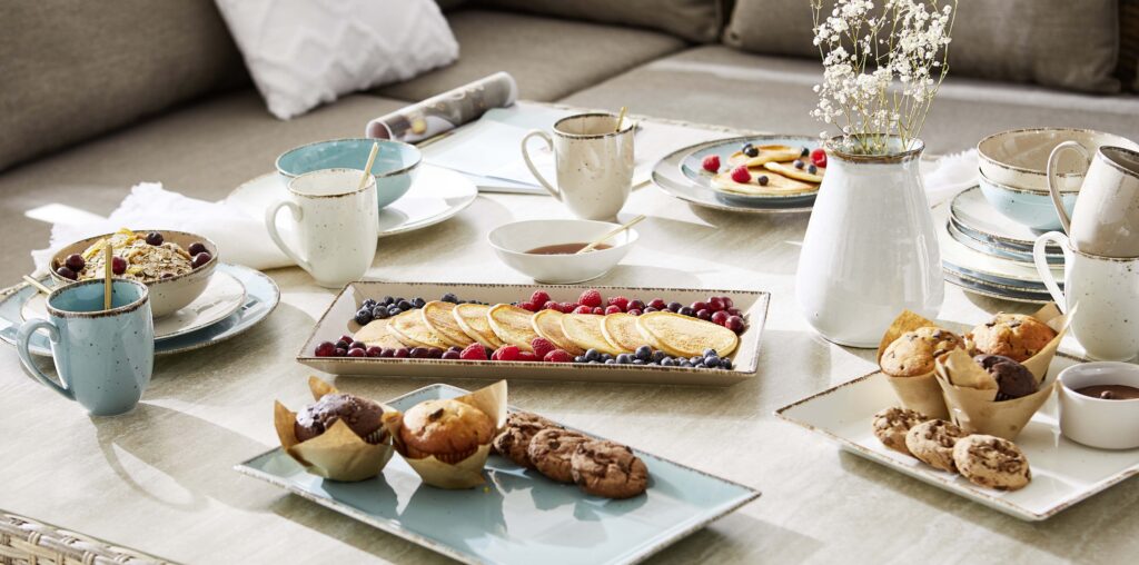 Kerti parti vagy erkély brunch teríték némi dekorációval, tálcákkal és ínycsiklandó ételekkel. 