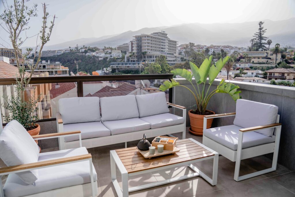 Modern stílusú erkély egyszerű vonalvezetésű bútorokkal, letisztult dizájnnal és funkcionális kiegészítőkkel.